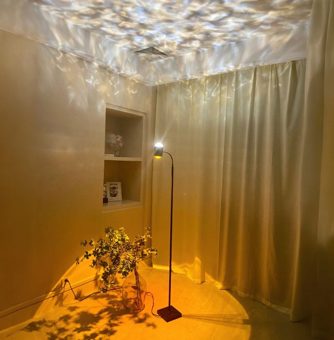 Dual-head RGB ambient floor lamp projecting sunset and ripple light effects on ceiling and walls, modern cozy room decor